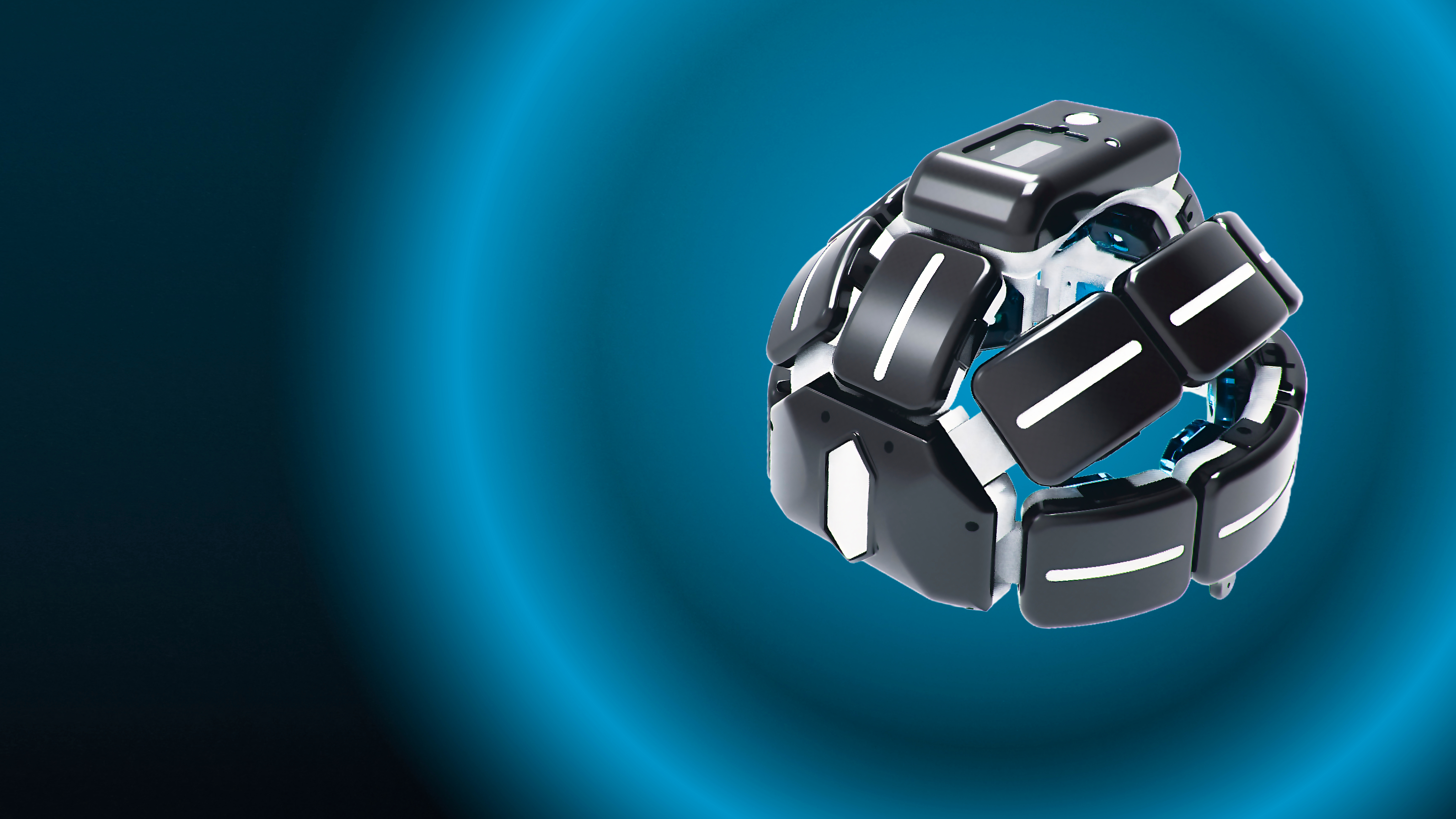 Photo of two women and a man talking in the corner of a room with modern furniture.